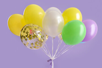 Beautiful balloons on lilac background