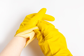 Man takes off his yellow rubber gloves after cleaning. White background