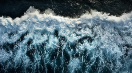 Aerial perspective as ocean waves crash upon the shore.