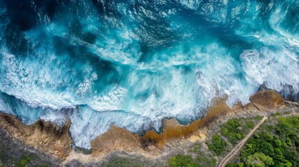 Aerial perspective as ocean waves crash upon the shore.