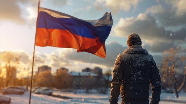 Man standing in snow with Russian flag, suitable for patriotic themes