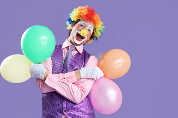 Portrait of clown with balloons on lilac background. April Fool's day celebration