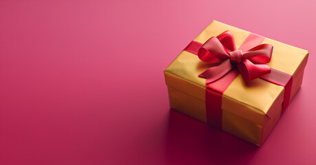 Obraz premium Gold box with a red bow on top. Box on a pink background -04