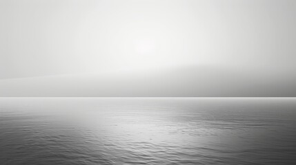 Minimalist monochrome seascape with mist and soft light.
