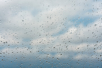 Raindrops on window glass surface, background texture