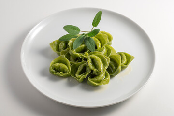 Dinner plate with green ravioli and sage