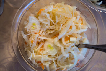 Sauerkraut with carrots in a plate. The view of top
