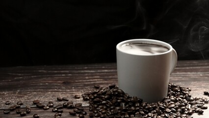 Top view of coffee or espresso with piles of coffee beans. Close up of fresh roasted coffee bean scatter around wooden table with cup of americano and aromatic stream and smoke from seed. Comestible.