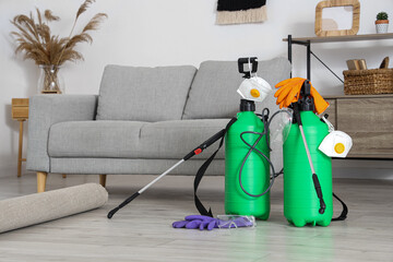 Disinfectant cylinders with protective masks and gloves in living room