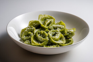 Pasta Bowl of green ravioli with parmesan