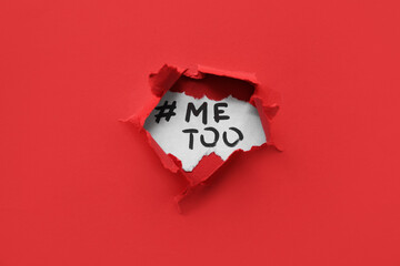 Hashtag METOO visible through torn red paper