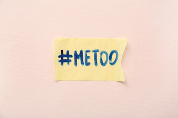 Torn paper piece with hashtag METOO on beige background