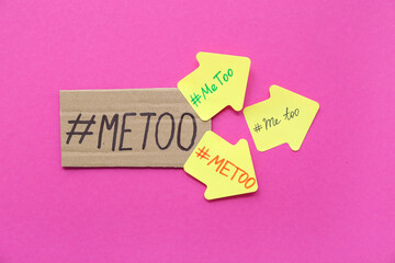 Papers with hashtags METOO on pink background