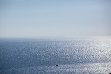 A small sailing boat sails on the sea surface of the Adriatic Sea. Balkans. View from above....