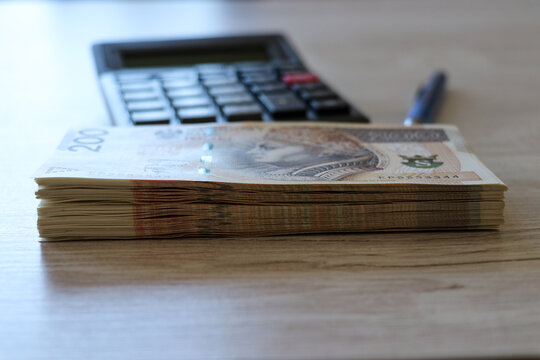 Polish banknotes spread out on the desk, PLN 100, PLN 200, PLN 500