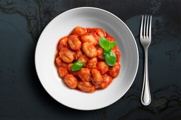 White bowl with tomato potato gnocchi
