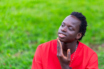 Man Sitting on Grass Covered Field