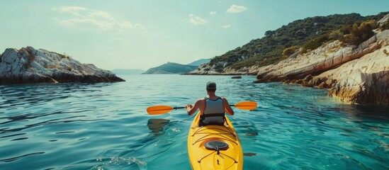 Solitary male kayaker in blue waters, summer outdoor adventure, picturesque coastal scenery view