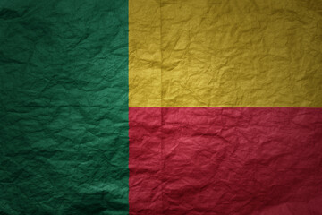 big national flag of benin on a grunge old paper texture background