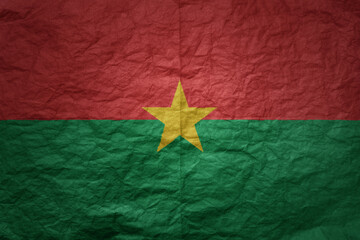 big national flag of burkina faso on a grunge old paper texture background