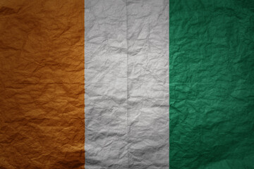 big national flag of cote divoire on a grunge old paper texture background