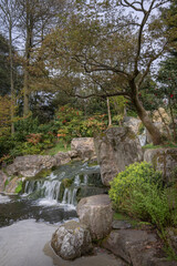 Waterfall in Kyoto Garden, a Japanese garden in Holland Park, London, UK. Holland Park is a public park with woods and gardens in the London borough of Kensington.