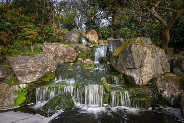Waterfall in Kyoto Garden, a Japanese garden in Holland Park, London, UK. Holland Park is a public park with woods and gardens in the London borough of Kensington.