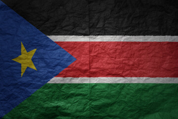 big national flag of south sudan on a grunge old paper texture background