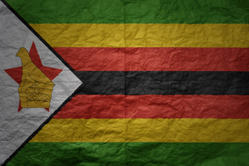 big national flag of zimbabwe on a grunge old paper texture background