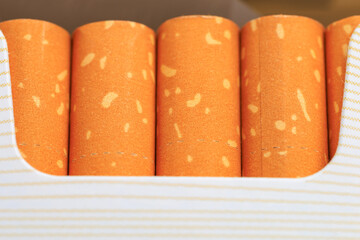 Pack of cigarettes with orange and white stripes