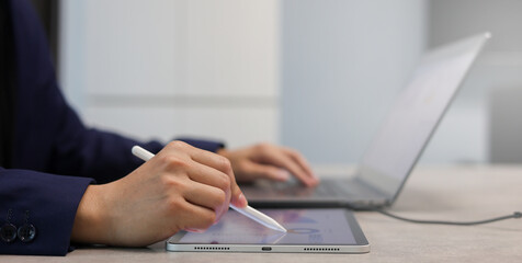 close up salesman employee hand using stylus pen to pointing on tablet screen to check company...