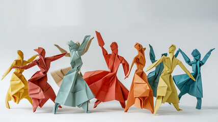 Colorful origami paper figures depicting a dance, arranged in a line on a white background.