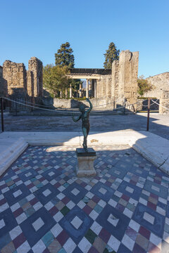 House of the Faun or Casa del Fauno with bronze statue at the ruins of Pompeii, Campania, Italy