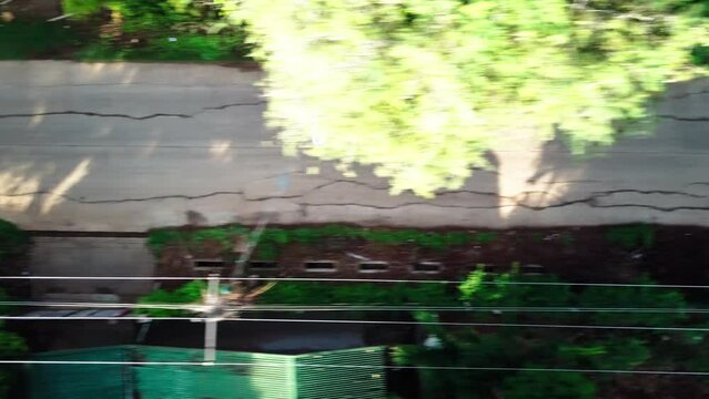 Aerial Top Panning Shot Of Vehicle Moving On Road By Green Trees - Puerto Princesa, Philippines