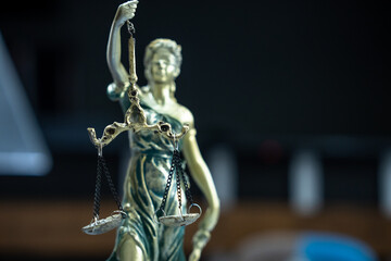 Statuette of justice, the blindfolded girl with scales. Concept of law