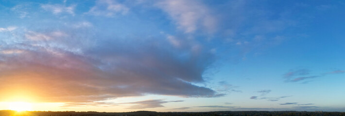 Fototapeta na wymiar High Angle Panoramic View of Sky and Colourful Clouds over England During Sunrise. 