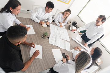 Decision-making in the engineering company.  A business meeting at an engineering firm, where professionals discuss projects and delivery dates. The atmosphere is collaborative and focused 