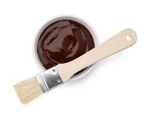 Marinade in bowl and basting brush isolated on white, top view