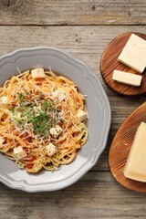 Vegetarian meal. Tasty pasta with fresh microgreens and cheese on wooden table, flat lay