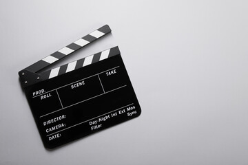 Fototapeta na wymiar Clapperboard on gray background, top view. Space for text