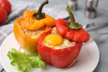 Delicious stuffed peppers with egg on grey table, closeup