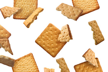 Tasty dry crackers falling on white background