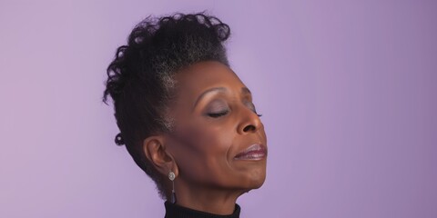 Serene middle-aged Black woman with natural hair, closing her eyes in contentment against a lavender-colored background