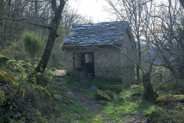 Mountain shelter in the forest built with stone and slate roof to sleep or take refuge
