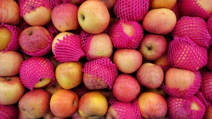A pile of apple fruit displayed in supermarket to attract the customers to buy