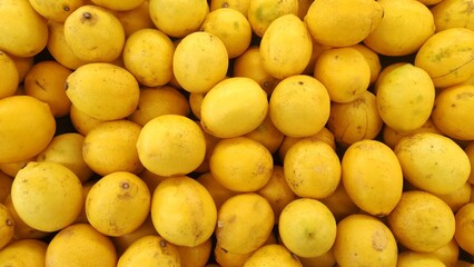 A pile of lemon displayed in supermarket to attract the customers to buy