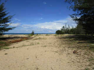 unspoiled natural beach with blue sea and sky