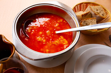 Spanish food callos with chickpeas, pepper and beef tripe, served in bowl, bread at plate