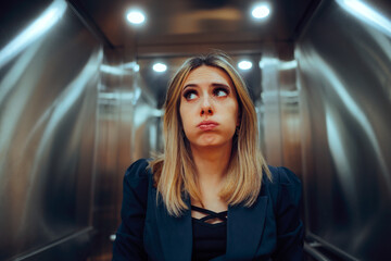 Anxious Office Worker Riding an Elevator at the Workplace. Stressed businesswoman feeling trapped...