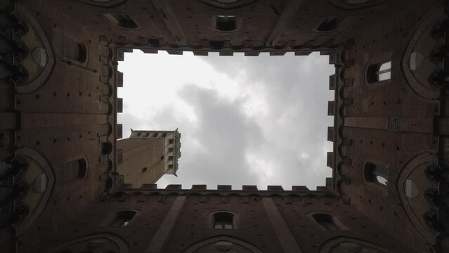 time lapse duomo Siena, Tuscany  Italy, looking up with medieval decoration framing the old bell tower and clouds passed by